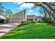 Charming single-Gathering home featuring well-maintained landscaping and a cozy two-car garage, perfect for suburban living at 11712 Palmer Dr, Tampa, FL 33624