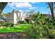 Lush landscaped front yard highlighting a modern home with an attached garage at 11712 Palmer Dr, Tampa, FL 33624
