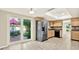 Modern kitchen featuring stainless steel appliances, ample cabinet space, and a view of the backyard patio at 11712 Palmer Dr, Tampa, FL 33624