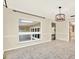 Open living room featuring neutral tones, tile flooring, and a contemporary chandelier, great for entertaining at 11712 Palmer Dr, Tampa, FL 33624