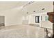 Open-concept living space with steps leading to the front entrance, and a view of a stone fireplace at 11712 Palmer Dr, Tampa, FL 33624