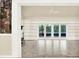 Bright living room featuring a stone fireplace, built-in shelving, and sliding glass doors to the outdoor patio at 11712 Palmer Dr, Tampa, FL 33624