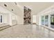 Spacious living room featuring a stone fireplace and built-in shelving with views of the outdoor space at 11712 Palmer Dr, Tampa, FL 33624