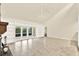 Bright and open living room featuring built-in shelving and sliding doors to the outdoor patio space at 11712 Palmer Dr, Tampa, FL 33624