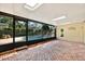 Enclosed pool area featuring skylights, brick flooring, and a view of the pool at 11712 Palmer Dr, Tampa, FL 33624