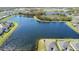 Lakeside aerial view of the homes showcases tranquil scenery and neighborhood layout from a high-angle perspective at 11714 Wrought Pine Loop, Riverview, FL 33569