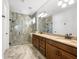 Spacious bathroom featuring a double vanity with granite counters and large walk-in shower at 11714 Wrought Pine Loop, Riverview, FL 33569