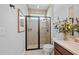 Modern bathroom with a glass-enclosed shower, neutral tile, and stylish fixtures at 11714 Wrought Pine Loop, Riverview, FL 33569
