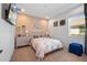 Cozy bedroom with peach-colored walls, decorative headboard, and a TV mounted on the wall at 11714 Wrought Pine Loop, Riverview, FL 33569