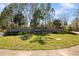 Beautiful community entrance sign surrounded by lush landscaping and mature trees at 11714 Wrought Pine Loop, Riverview, FL 33569