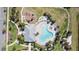 Bird's eye view of the community pool with a clubhouse, lounge chairs and a nearby playground and walking trails at 11714 Wrought Pine Loop, Riverview, FL 33569