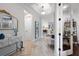 Elegant entryway featuring hardwood floors, a stylish mirror, and views into the living spaces at 11714 Wrought Pine Loop, Riverview, FL 33569