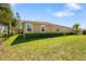 Exterior view of the home showing the well-maintained lawn and neatly trimmed hedges at 11714 Wrought Pine Loop, Riverview, FL 33569