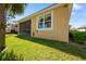 Exterior shot of the home showcasing the well-maintained lawn and the screen patio at 11714 Wrought Pine Loop, Riverview, FL 33569