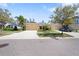 Well-maintained house exterior with double car garage and mature landscaping and street view at 11714 Wrought Pine Loop, Riverview, FL 33569