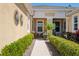 Charming covered front porch with well-maintained landscaping and decorative wall art at 11714 Wrought Pine Loop, Riverview, FL 33569