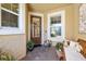 Charming front porch featuring a glass door, decorated with plants and a cozy bench at 11714 Wrought Pine Loop, Riverview, FL 33569