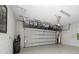 Clean garage featuring overhead storage racks, white block walls, and an epoxy-coated floor at 11714 Wrought Pine Loop, Riverview, FL 33569
