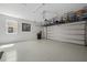 Spacious garage with epoxy flooring, storage racks, and ample room for parking at 11714 Wrought Pine Loop, Riverview, FL 33569