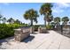 Outdoor grilling area features two built-in stainless steel grills with stone bases, perfect for entertaining in the community at 11714 Wrought Pine Loop, Riverview, FL 33569