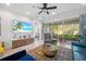 Open living room with sliding glass doors to outdoor patio providing natural light at 11714 Wrought Pine Loop, Riverview, FL 33569