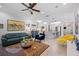 Inviting living room showcasing modern furnishings, herringbone flooring, and stylish decor at 11714 Wrought Pine Loop, Riverview, FL 33569