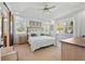 Inviting bedroom with tray ceiling, bright windows, and comfortable decor at 11714 Wrought Pine Loop, Riverview, FL 33569