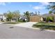 Street view of house with driveway, lawn and landscaping at 11714 Wrought Pine Loop, Riverview, FL 33569