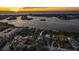 An aerial view showcasing a coastal neighborhood with waterfront access and stunning sunset views at 12808 Harborwood Dr, Largo, FL 33774