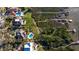 Beautiful aerial view of an estate home with pool, landscaping, private boardwalk and dock on the water at 12808 Harborwood Dr, Largo, FL 33774