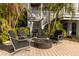 Charming backyard fire pit area surrounded by mature trees and comfortable seating at 12808 Harborwood Dr, Largo, FL 33774