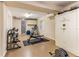 Well-equipped basement gym with weights, a workout bench, and a large safe at 12808 Harborwood Dr, Largo, FL 33774
