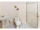 Bathroom featuring a glass-enclosed shower, toilet, a pedestal sink and decorative blue and white floors at 12808 Harborwood Dr, Largo, FL 33774