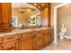 Bathroom featuring dual sinks with granite countertop and beautiful cabinetry with a chandelier at 12808 Harborwood Dr, Largo, FL 33774