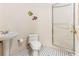 Cozy bathroom featuring a pedestal sink, toilet, and glass-enclosed shower at 12808 Harborwood Dr, Largo, FL 33774