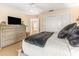 Bedroom with comfortable bed, dresser, and plush pillows with view to second story balcony at 12808 Harborwood Dr, Largo, FL 33774