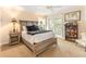 Bedroom featuring wood furniture, neutral tones, and a bookshelf with books and nautical decorations at 12808 Harborwood Dr, Largo, FL 33774