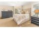 Bedroom with carpet, tufted headboard, a dresser, and natural light from the sunlit windows at 12808 Harborwood Dr, Largo, FL 33774
