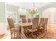 Elegant dining room with large wooden table, chandelier, and ample seating at 12808 Harborwood Dr, Largo, FL 33774