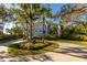 Stately home showcasing mature palm trees and a circular driveway, enhancing its curb appeal at 12808 Harborwood Dr, Largo, FL 33774