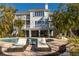 Stunning multi-story home with a pool and spacious outdoor lounge area at 12808 Harborwood Dr, Largo, FL 33774