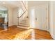 Bright foyer featuring hardwood floors, decorative glass door, and staircase leading to upper level at 12808 Harborwood Dr, Largo, FL 33774