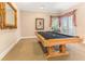 Well-lit game room featuring a pool table and French doors leading to the outside at 12808 Harborwood Dr, Largo, FL 33774