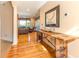 Hallway featuring hardwood floors, a decorative console table, and a glimpse into the living area at 12808 Harborwood Dr, Largo, FL 33774