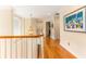 Spacious hallway with hardwood floors, white trim, an ornate chandelier, and access to multiple rooms at 12808 Harborwood Dr, Largo, FL 33774