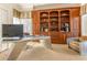 Home office with custom wood built-ins, unique desk, and comfortable seating at 12808 Harborwood Dr, Largo, FL 33774