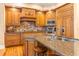 A detailed view of the kitchen, featuring custom wood cabinets and stainless steel appliances at 12808 Harborwood Dr, Largo, FL 33774