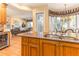 An open-concept kitchen with granite countertops, a double sink, and a view into the living room at 12808 Harborwood Dr, Largo, FL 33774