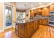 Spacious kitchen island with granite countertops, custom cabinetry, and bar stool seating at 12808 Harborwood Dr, Largo, FL 33774