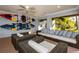 Covered outdoor lanai with comfortable seating and two kayaks hung on the wall for easy access at 12808 Harborwood Dr, Largo, FL 33774